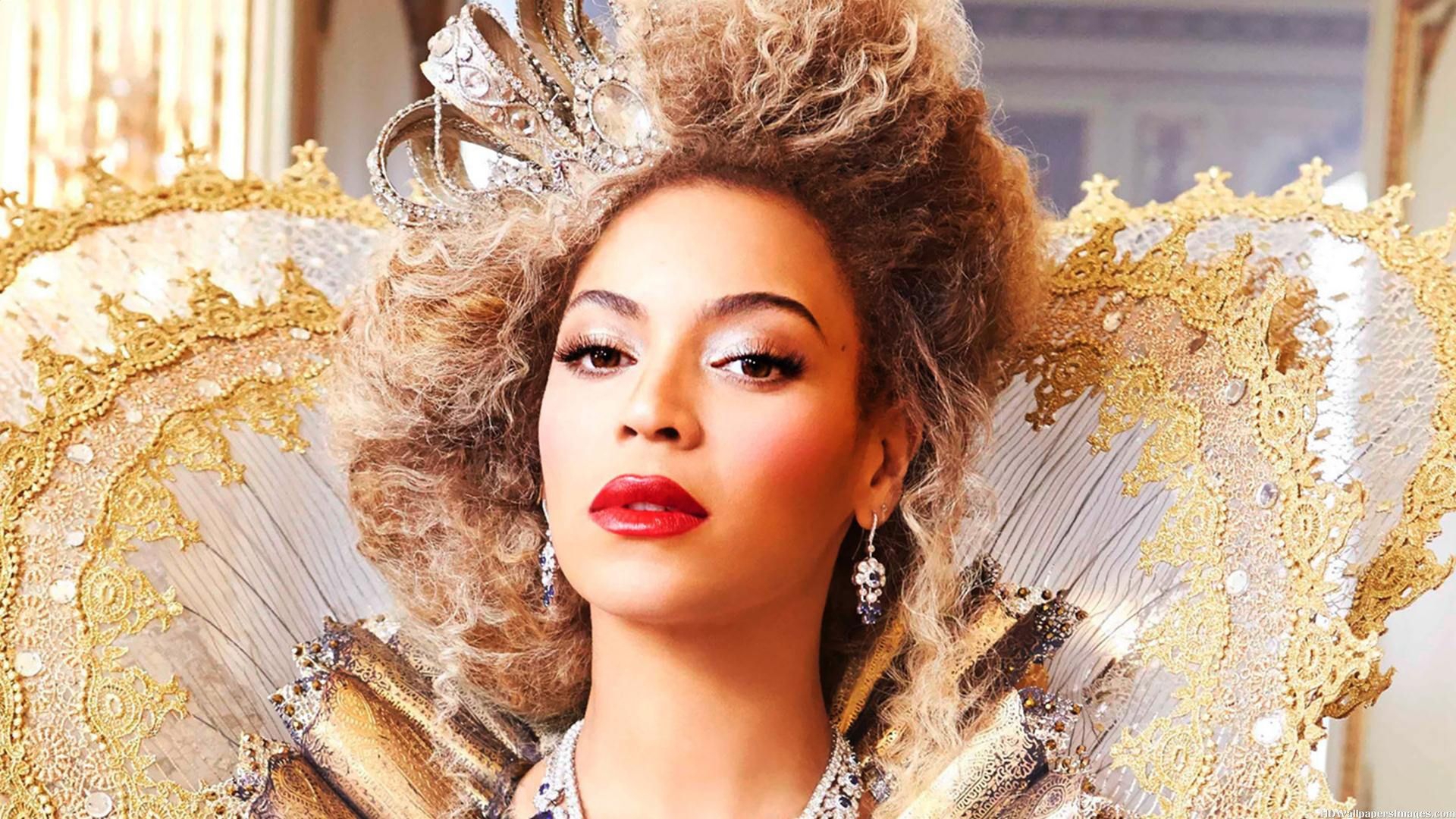 Beyoncé in a regal, gold and white costume and crown, possibly from a music video or photoshoot