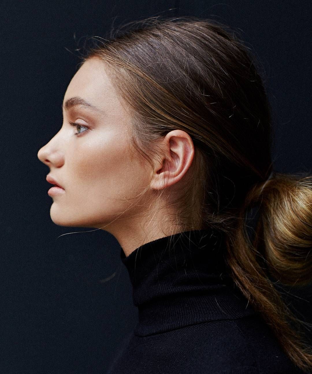 Stylish Woman In High Ponytail And Turtleneck Sweater Wallpaper