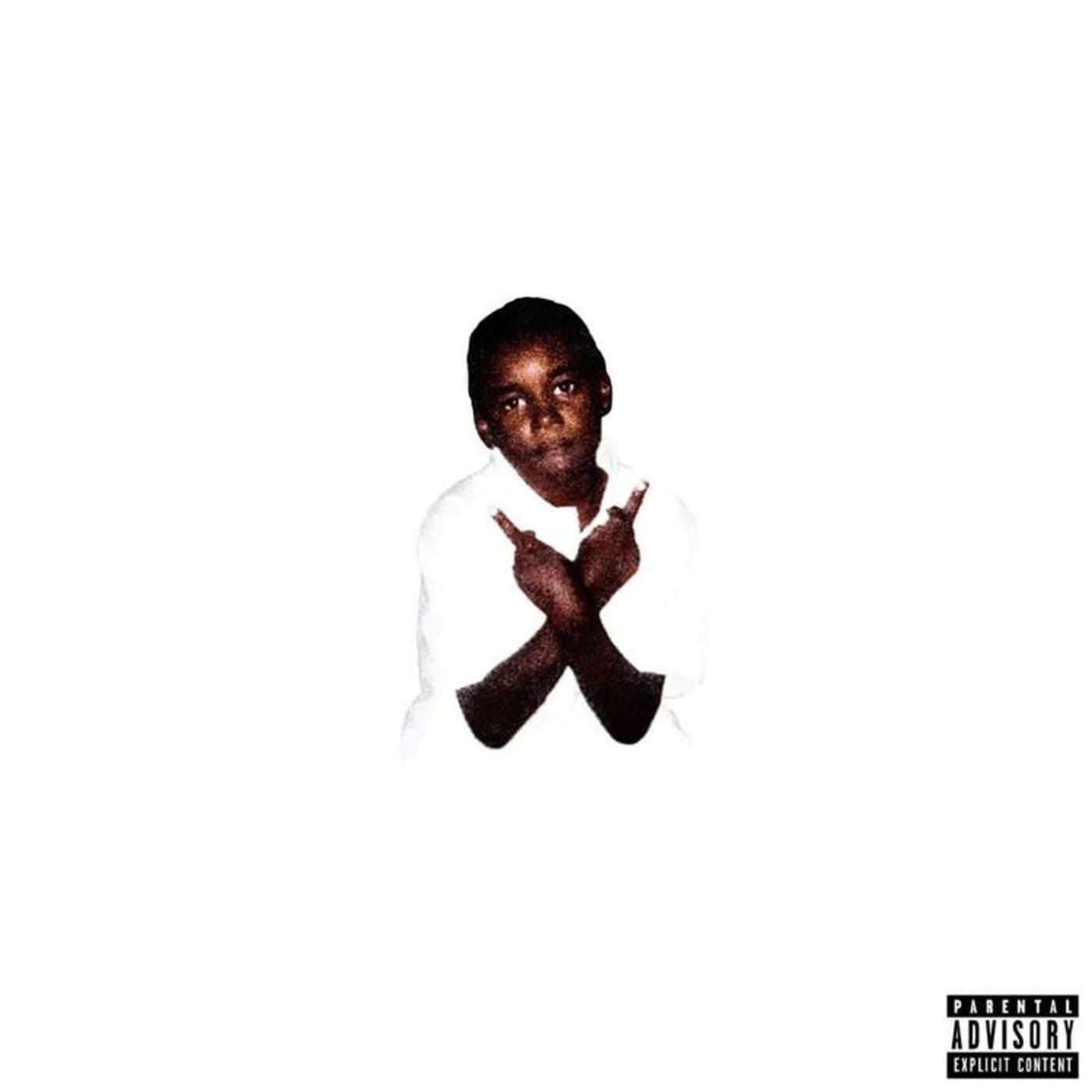 A young boy in a white shirt making a gesture with his hands