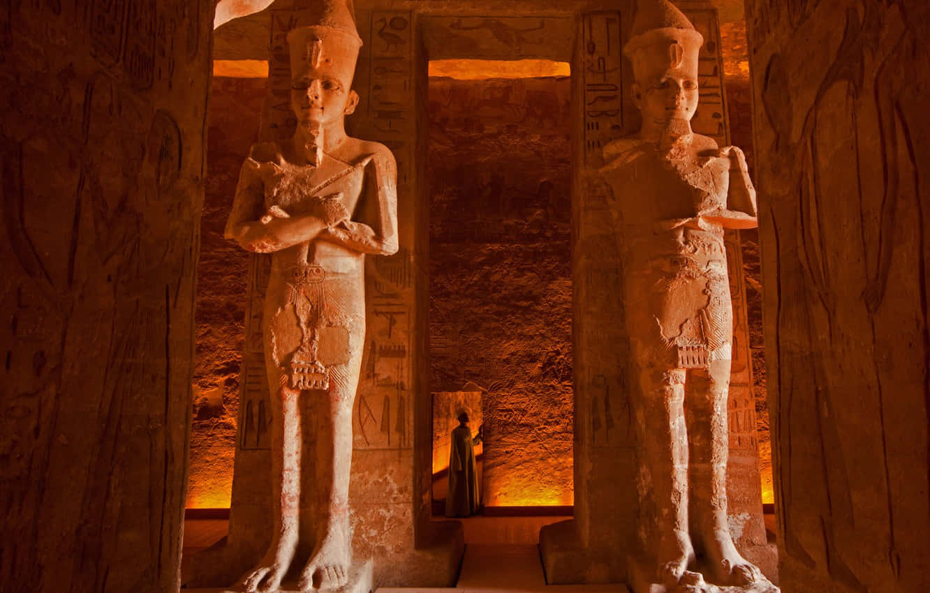 Orange Light Within The Statues Inside Egyptian Museum Wallpaper