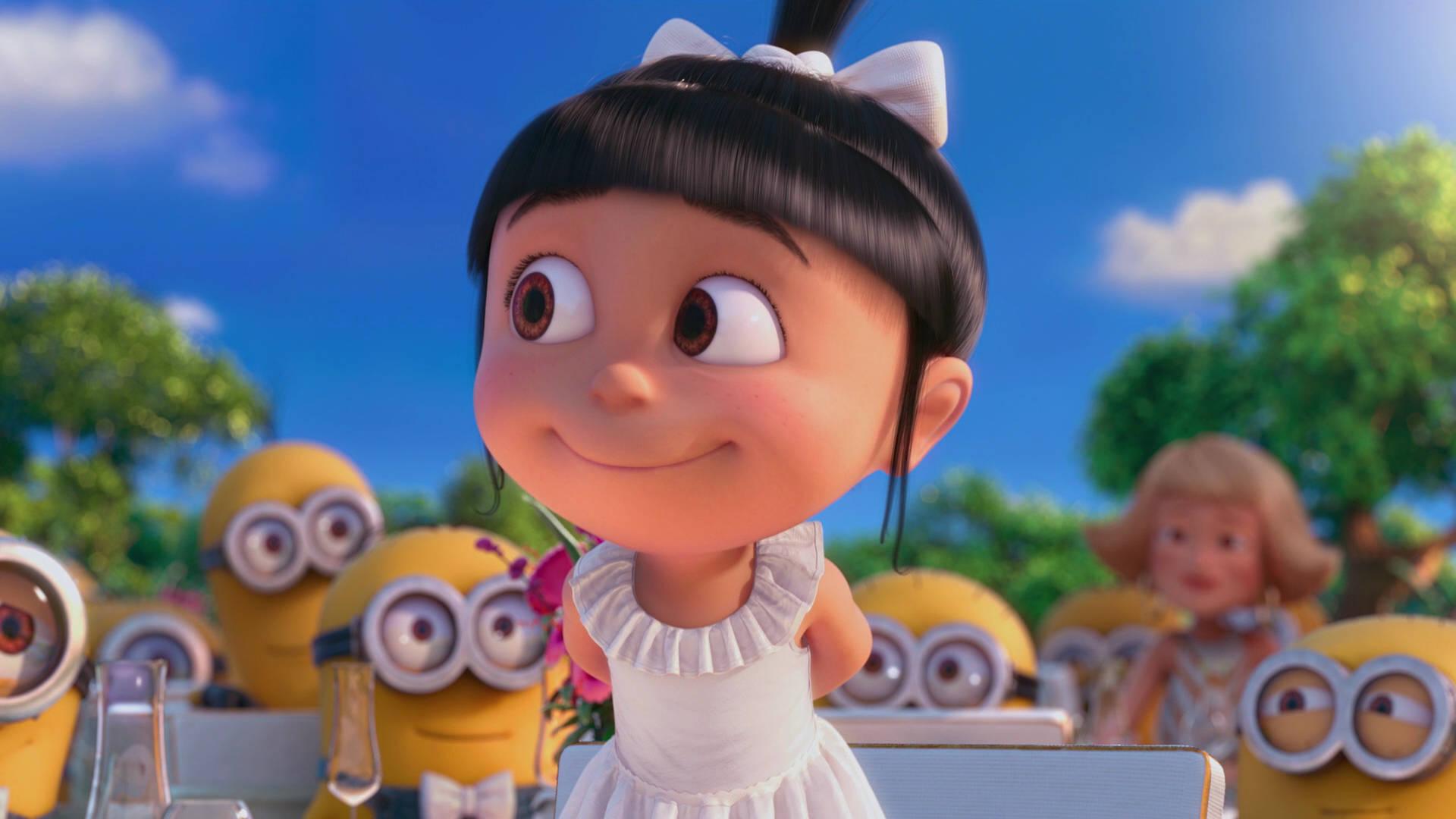 Agnes, the youngest of Gru's adopted daughters, smiles adorably in her white dress, surrounded by Minions in a scene from Despicable Me