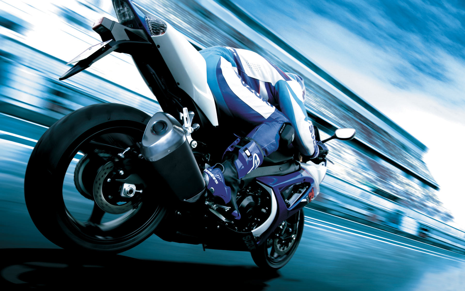 A Suzuki GSX-R sportbike speeding down a racetrack, showcasing its dynamic design and powerful performance