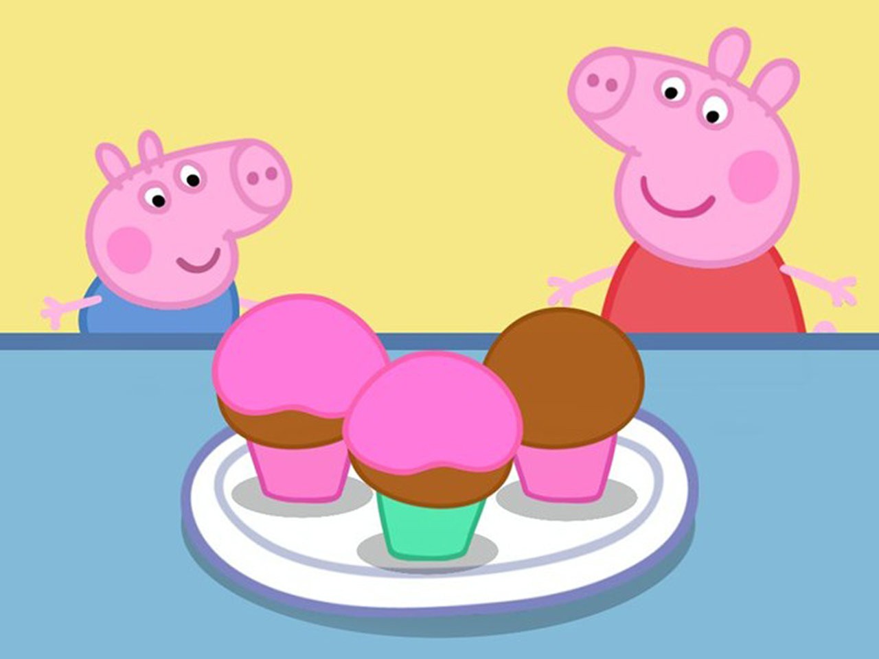 Peppa Pig and George looking at cupcakes on a plate