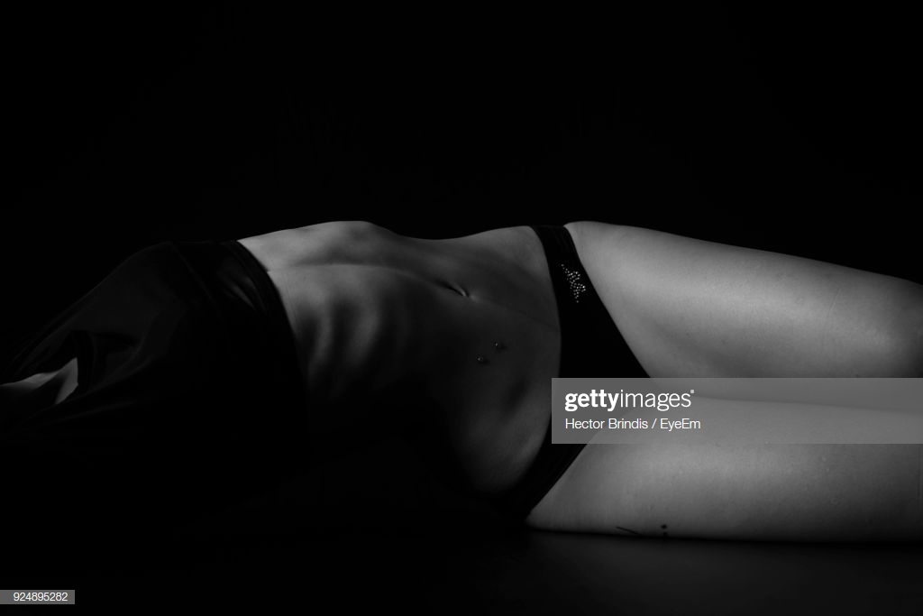Seductive Woman Lying Against Black Background Stock Photo Getty
