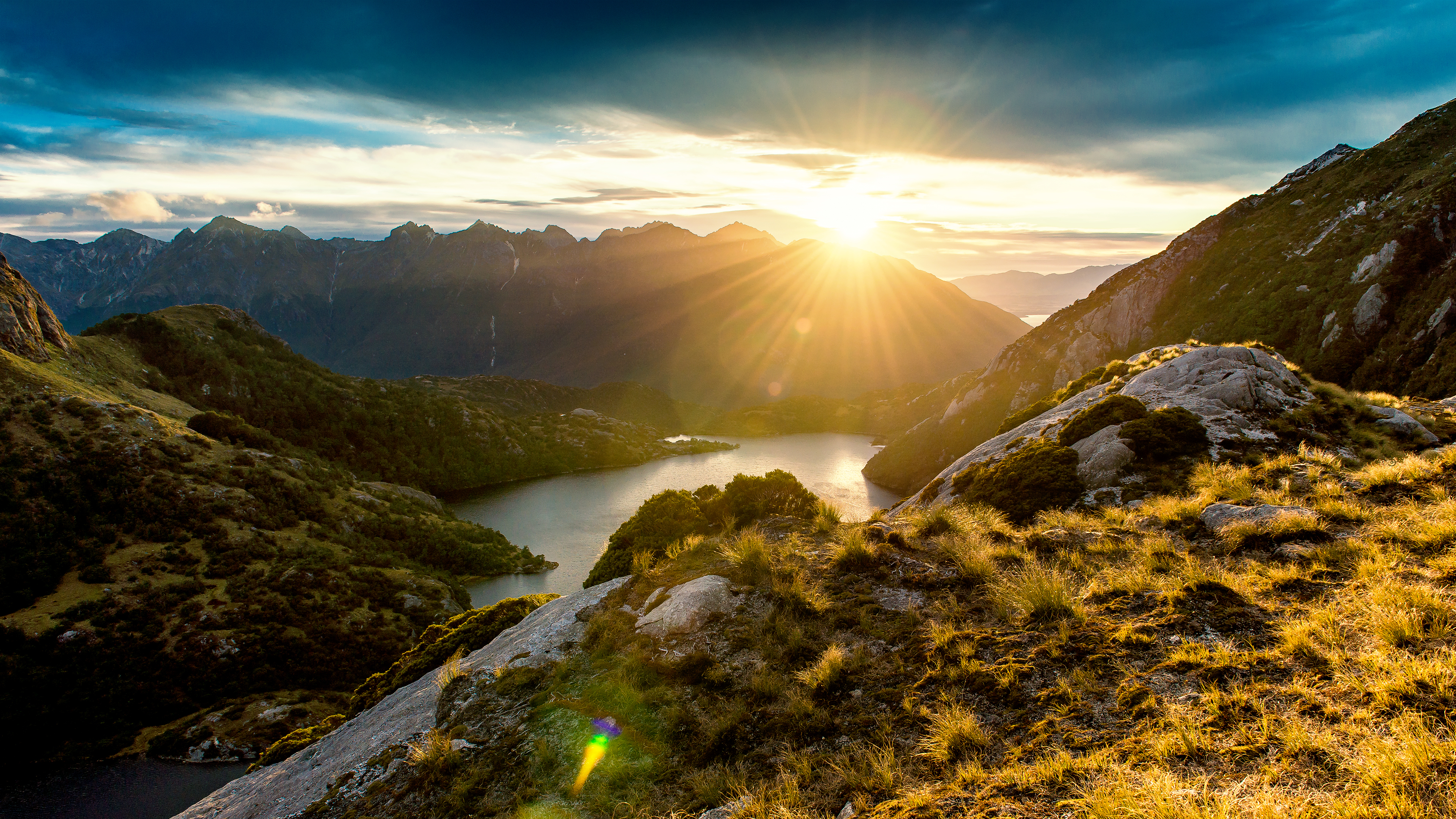 Stunning 4K wallpaper of a sunset over a mountain lake