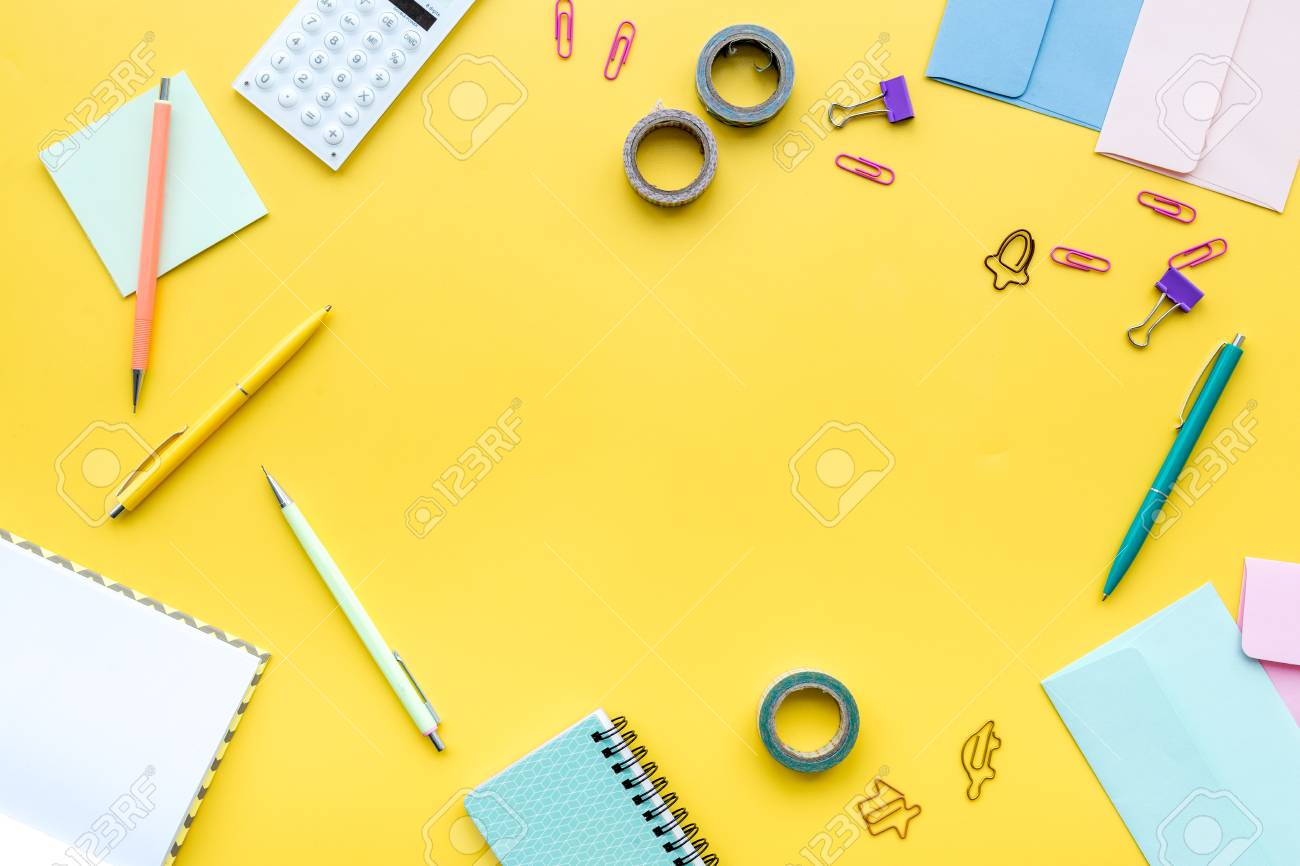Scattered Stationery On Student S Desk Yellow Background Top