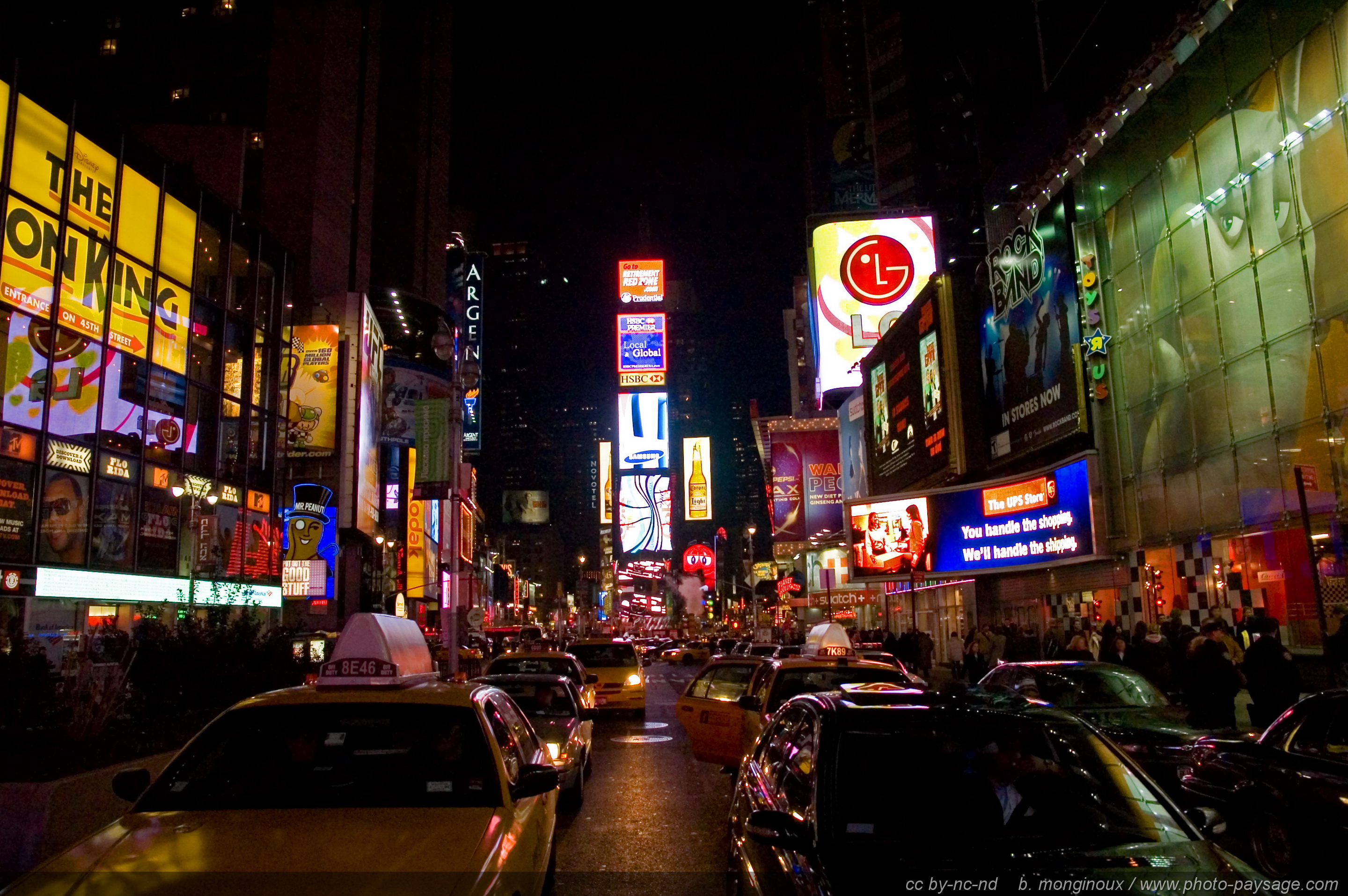 A vibrant night view of New York City's Times Square, showcasing the bright lights and bustling energy of Broadway