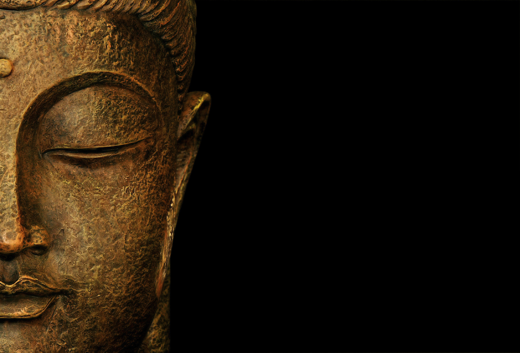Serene Buddha Face Close-Up on Dark Background
