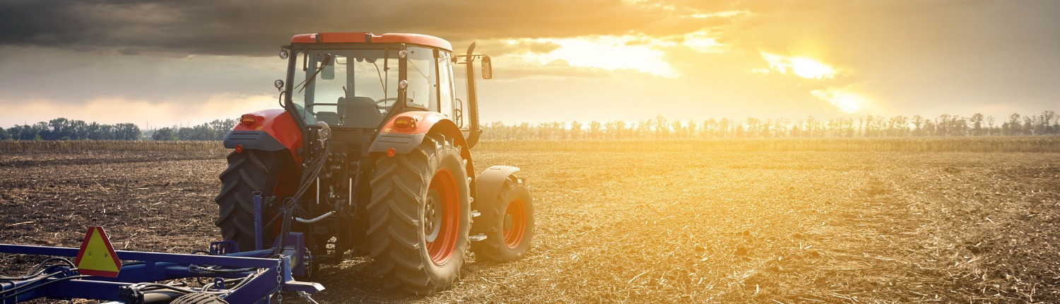 Tractor Working In The Field On A Sunset Background Picture