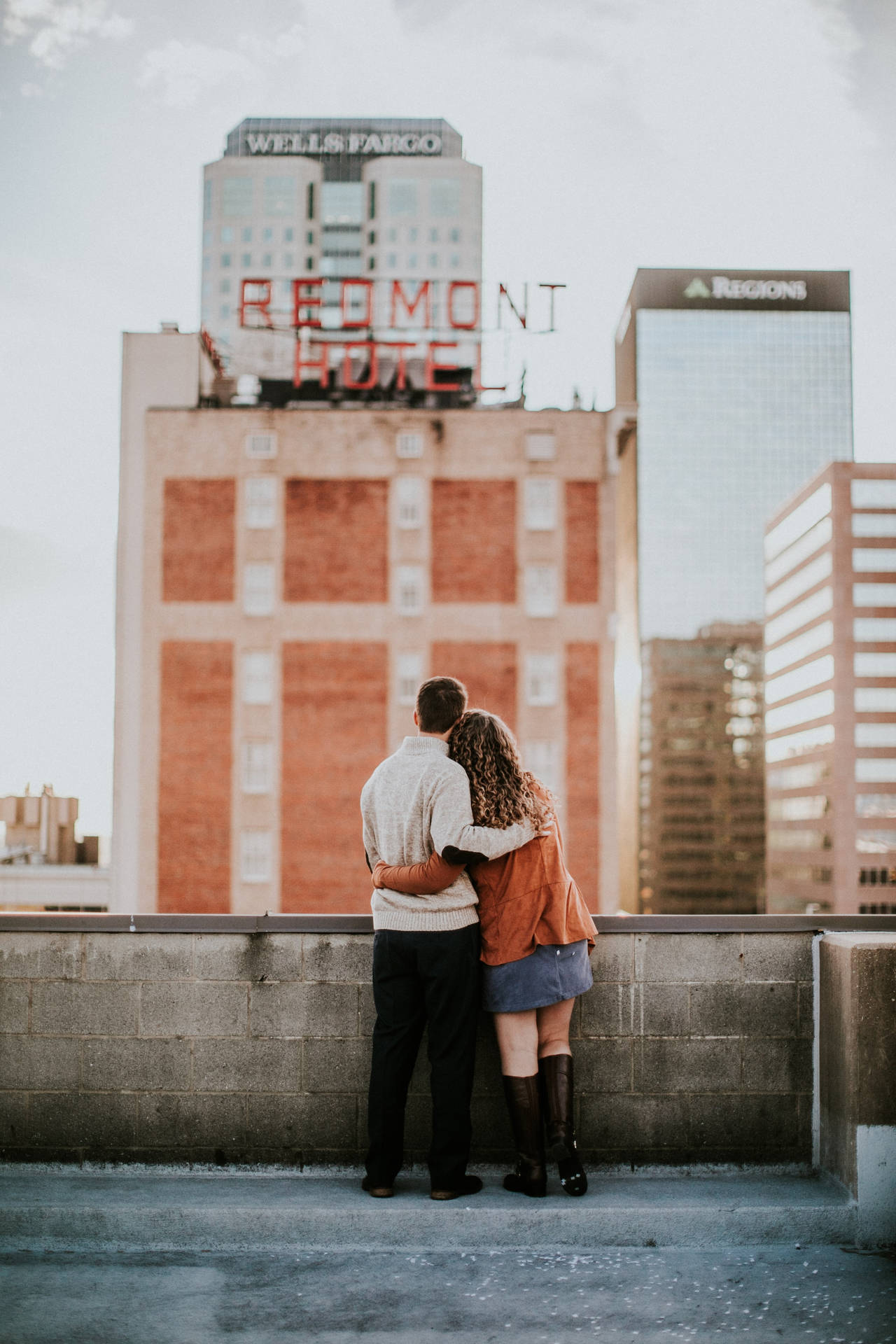 Couple Hugging Side By Downtown Birmingham Rooftop Wallpaper