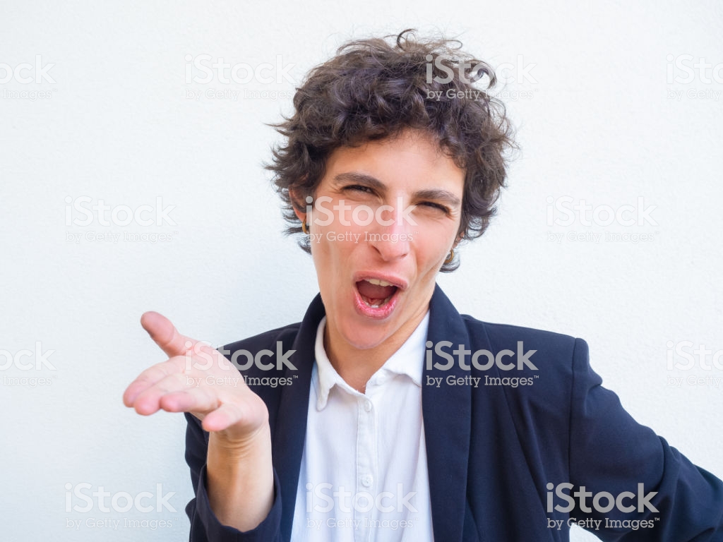 Skeptical Excited Businesswoman Speaking And Gesturing Stock Photo