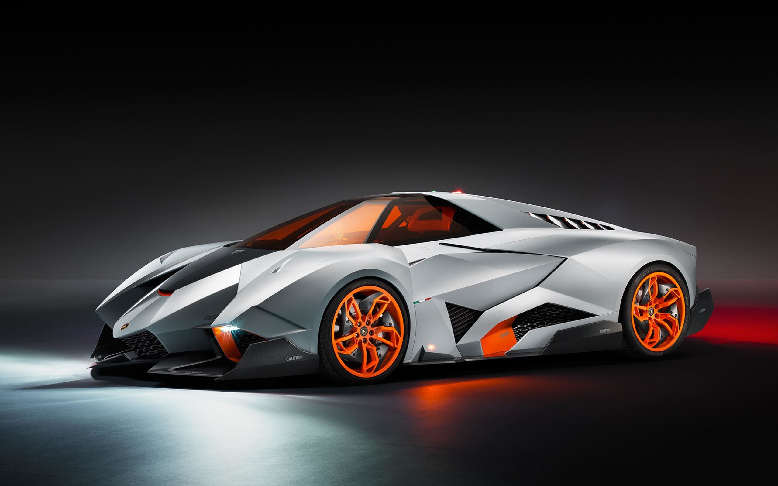A futuristic Lamborghini concept car with orange accents against a dark background