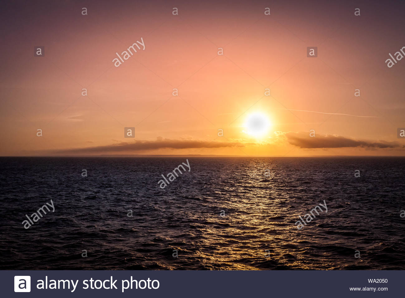 Sunset Behind The Horizon On Sea With Italian Coastline