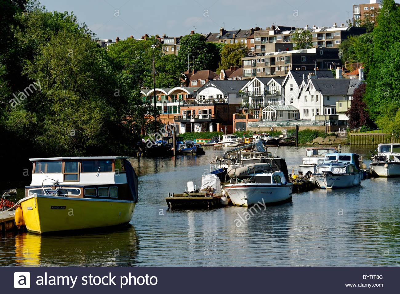 Boats Moored On The River Thames With Richmond In Background