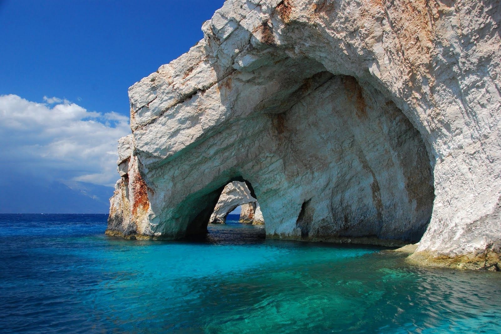 The mesmerizing Blue Caves of Zakynthos, Greece: A breathtaking natural wonder where turquoise waters meet majestic white cliffs