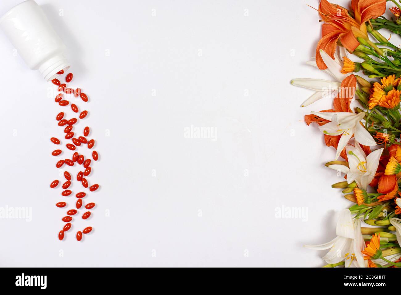 Orange capsules of lutein and medicinal plants on a white
