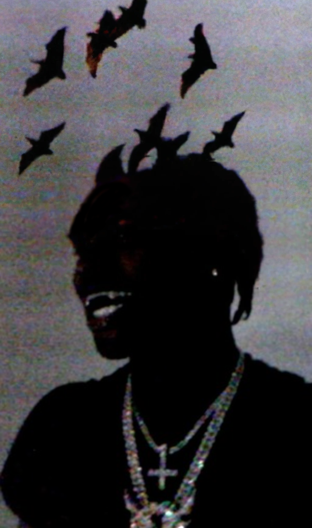 Silhouette of Ken Carson with bats in the background