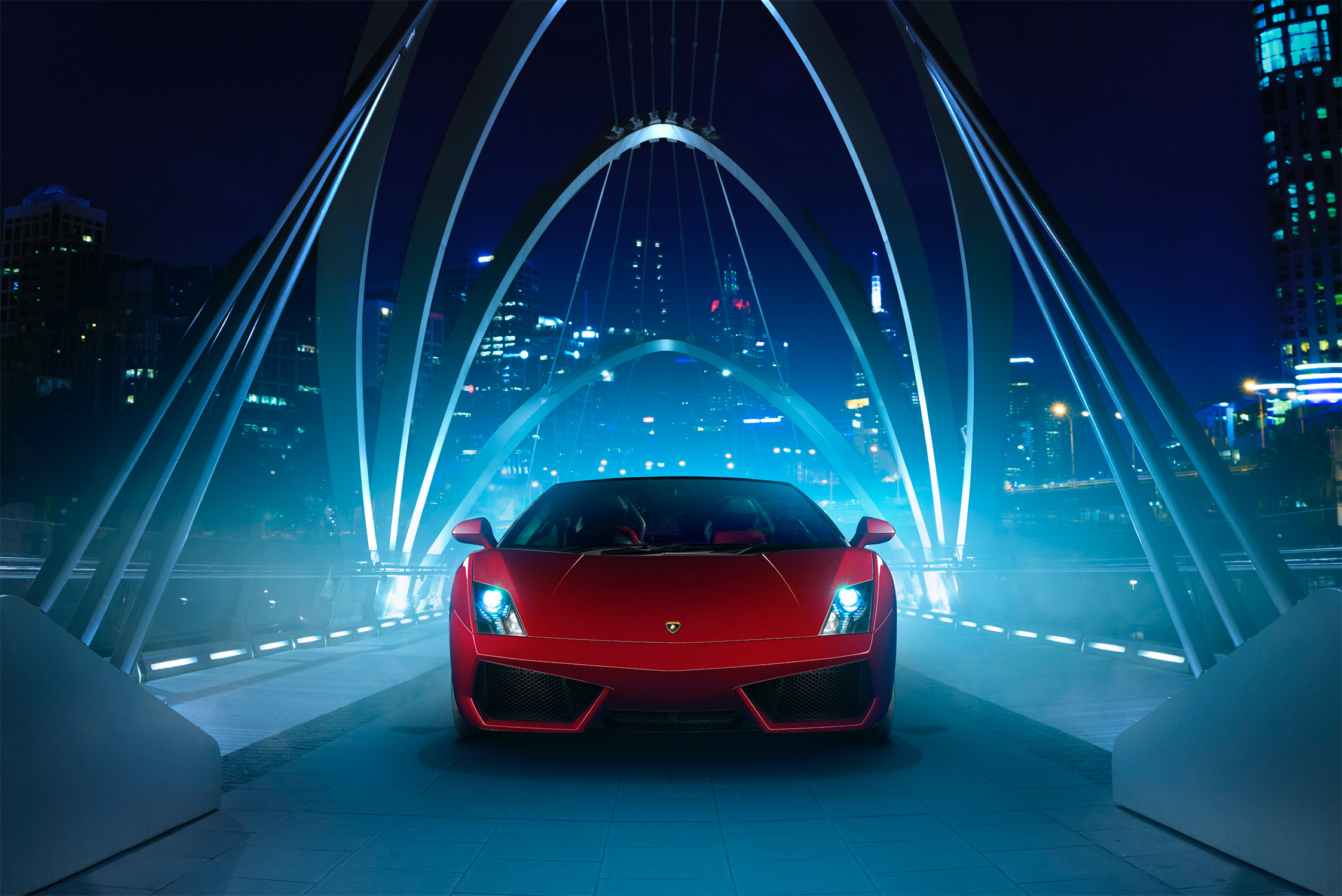 Red Lamborghini Gallardo on a bridge at night