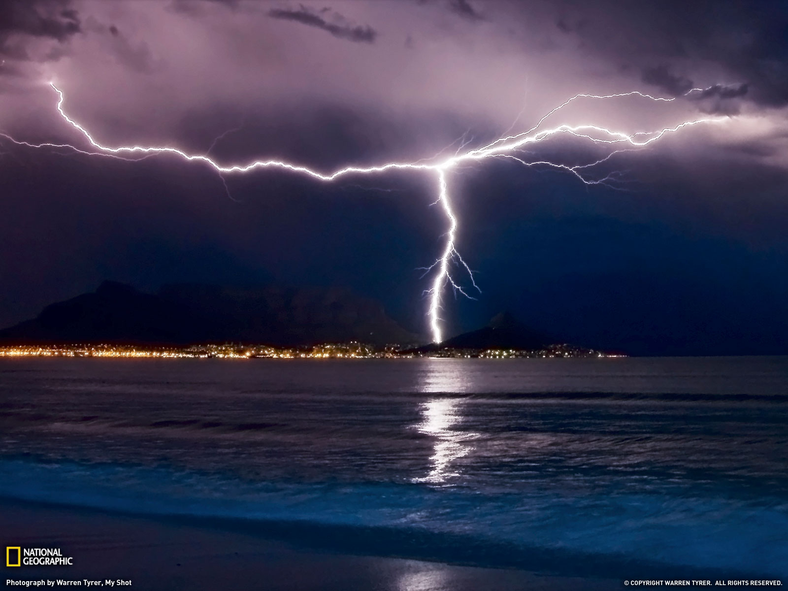 Two Separate Lightning Bolts Converge Over Table Mountain In Cape Town