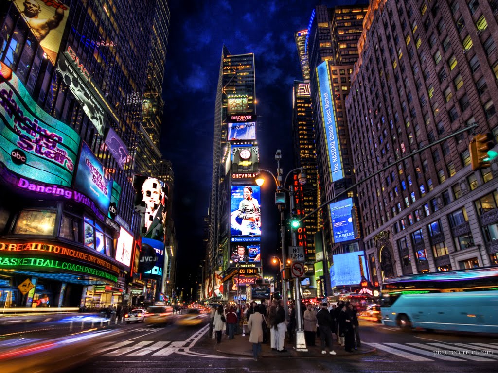 A vibrant night view of Times Square in New York City, showcasing dazzling billboards, bustling crowds, and the bright lights of Broadway