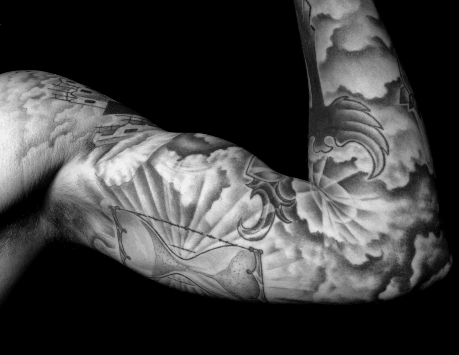 Black and Grey Tattoo Sleeve on a Muscular Arm