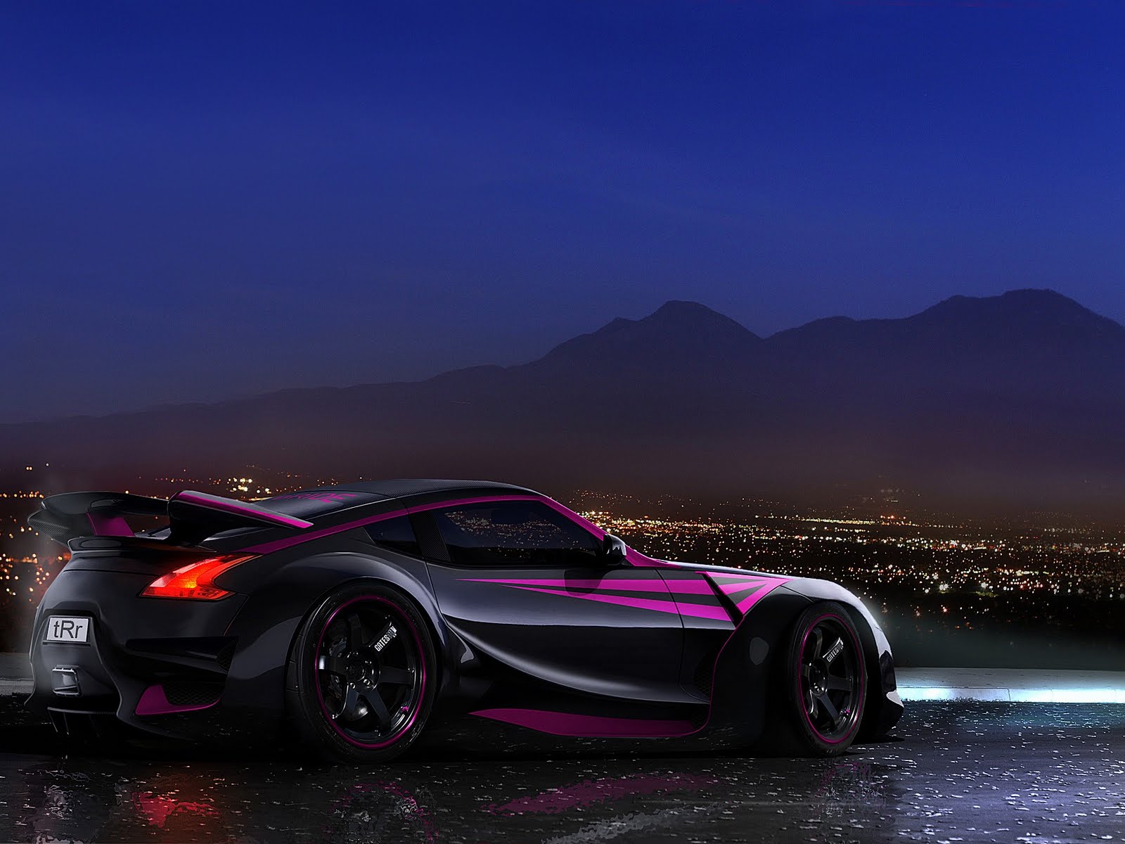 A sleek, black and pink customized Nissan 370Z sports car parked overlooking a cityscape at night, with mountains in the background