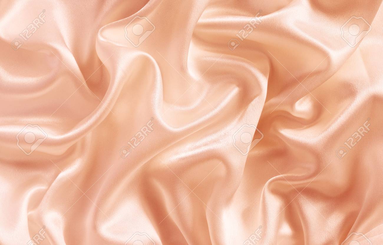 Closeup Of Peach Silk Fabric For Background Stock Photo Picture