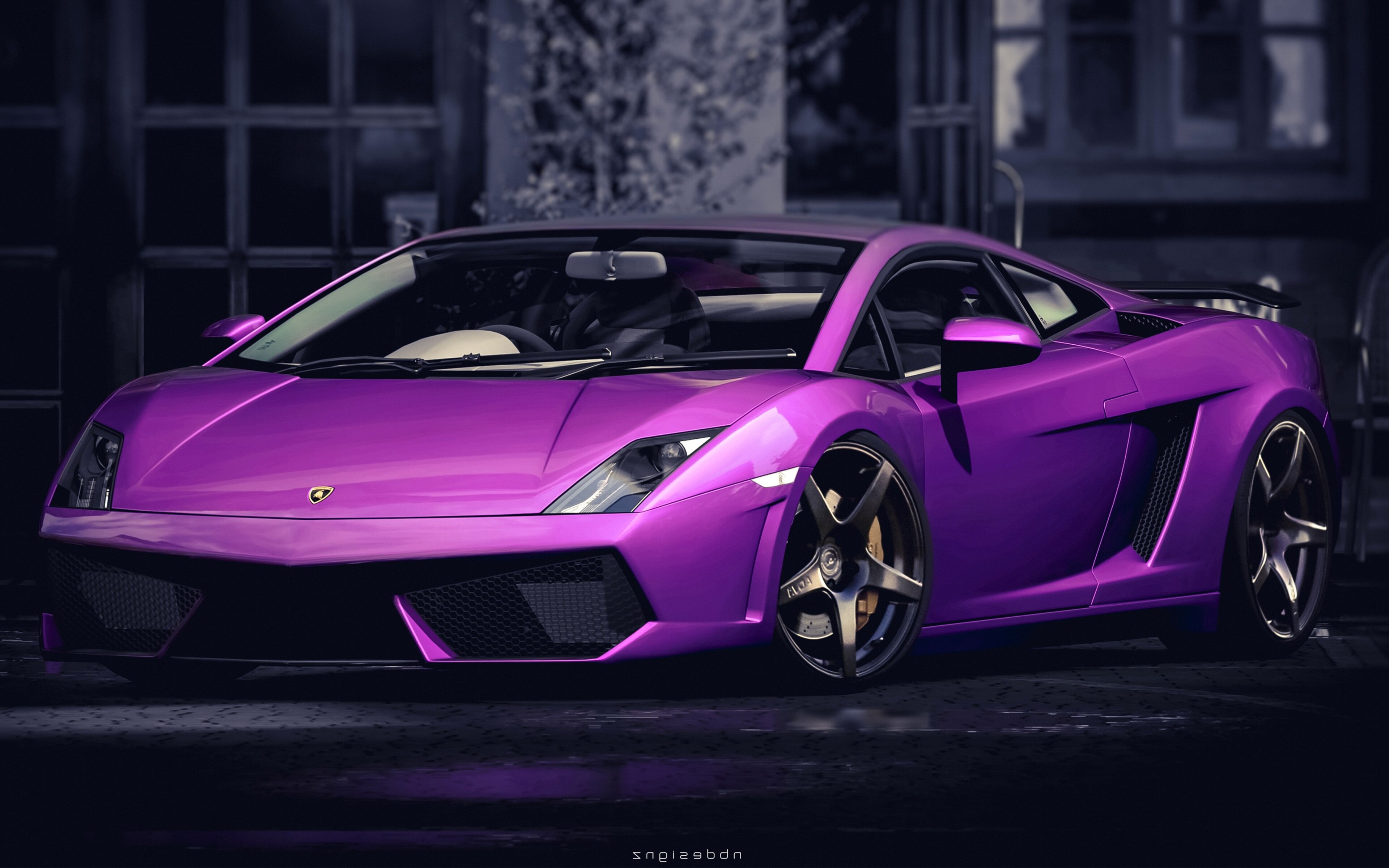 A vibrant purple Lamborghini Gallardo parked in front of a blurred urban background. The car's sleek design and bright color make it the focal point of the image