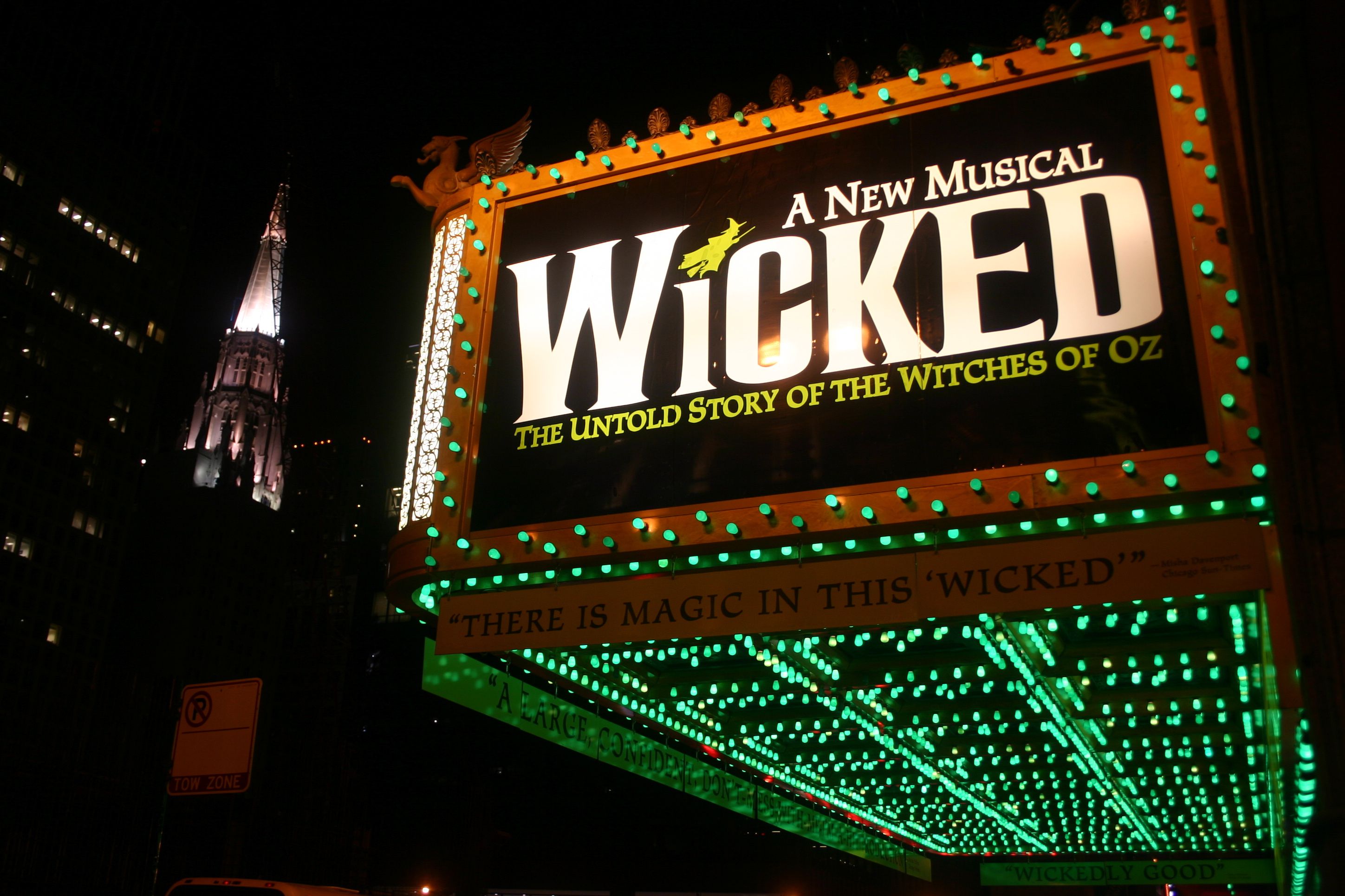 Wicked Broadway marquee at night with glowing green lights