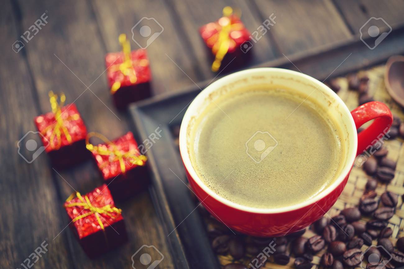 Coffee Cup And Christmas Redbox Decoration On Wooden Table