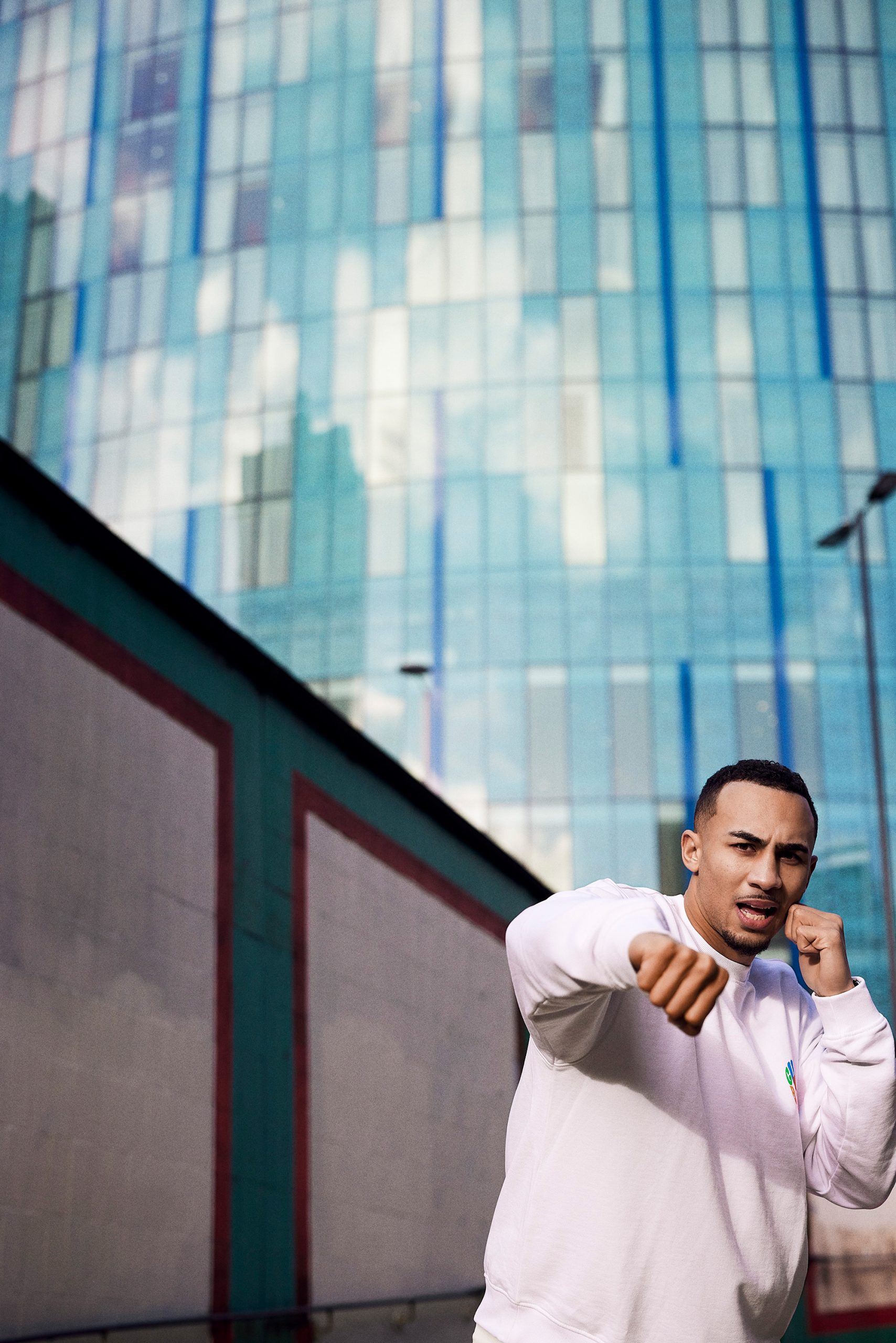 Benjamin Whittaker practicing boxing in front of a modern building