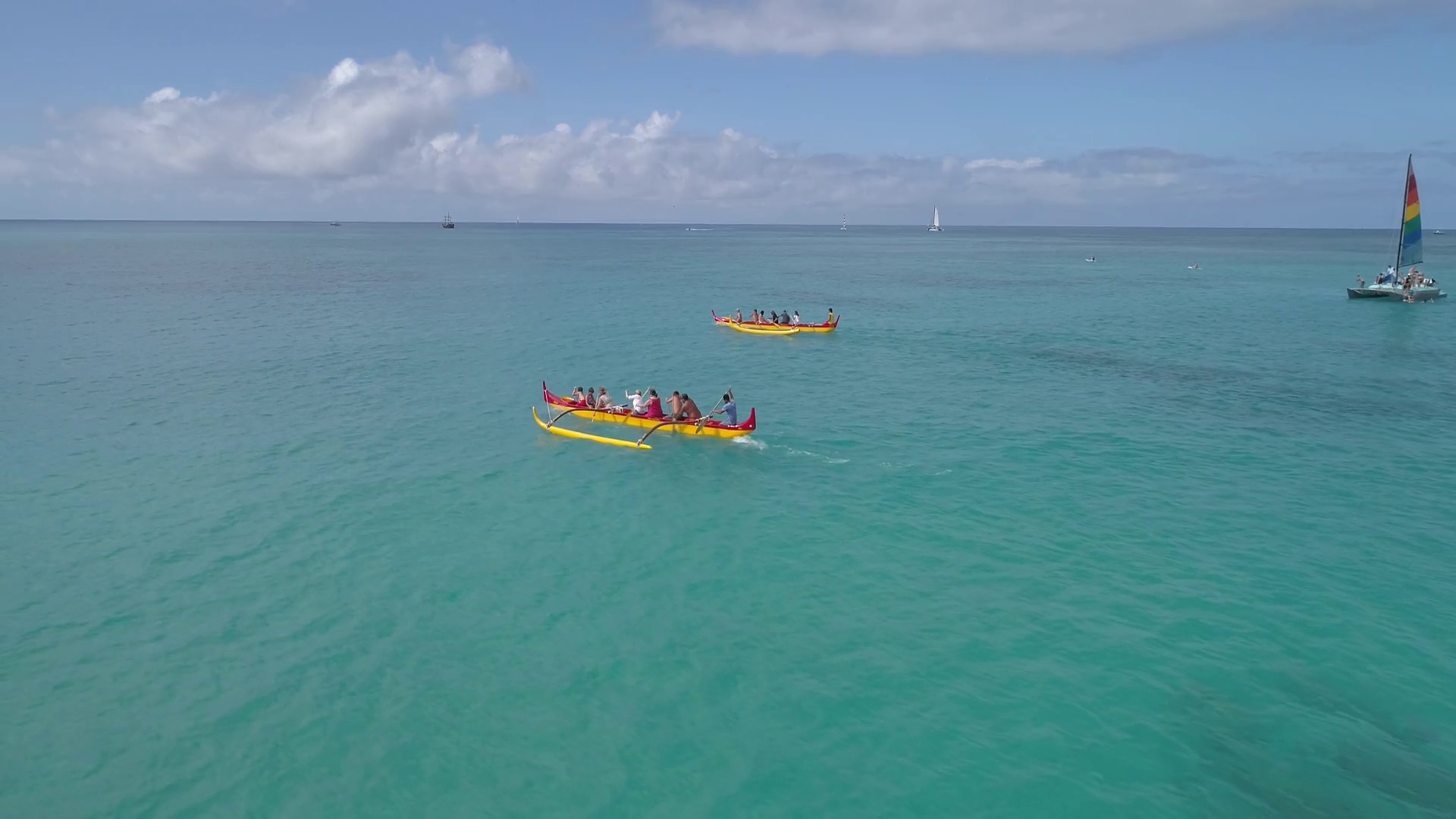 Slow Motion Aerial Video Of Outrigger Canoes In Waikiki Hawaii
