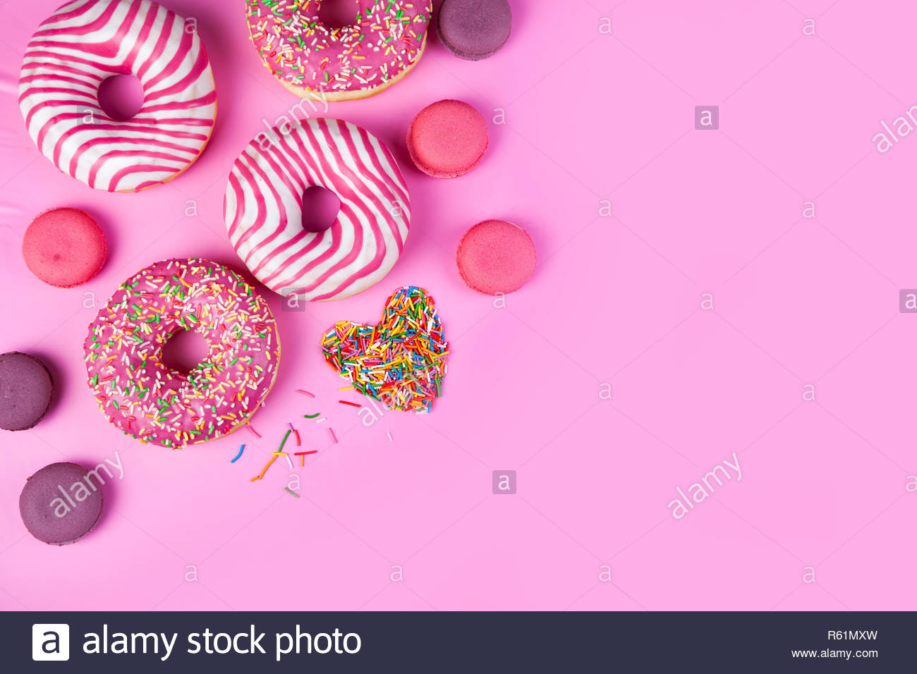 Donuts Macaroons And Confectionery Heart On A Pink Background