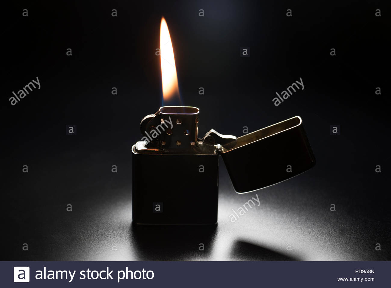 Zippo Lighter With Yellow Flame Isolated On Black Background Stock