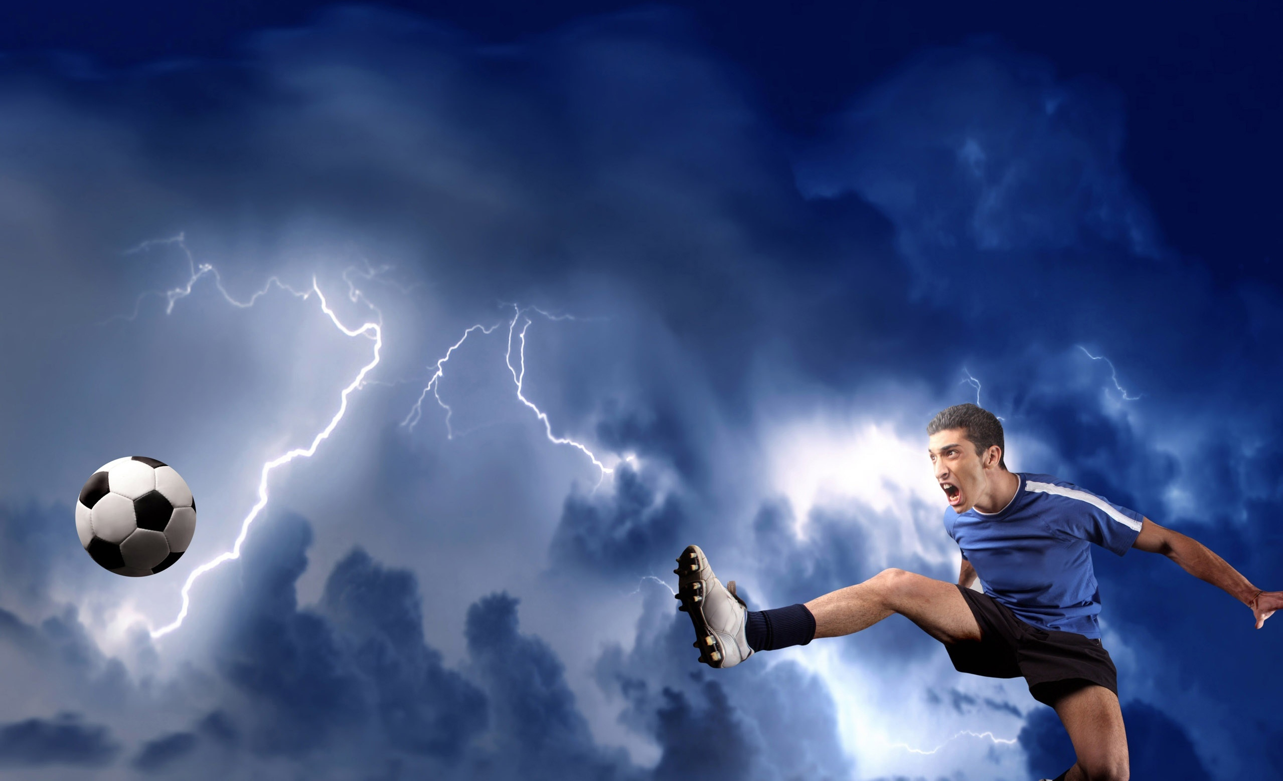 A football player dynamically kicks a soccer ball against a dramatic backdrop of a stormy sky filled with lightning