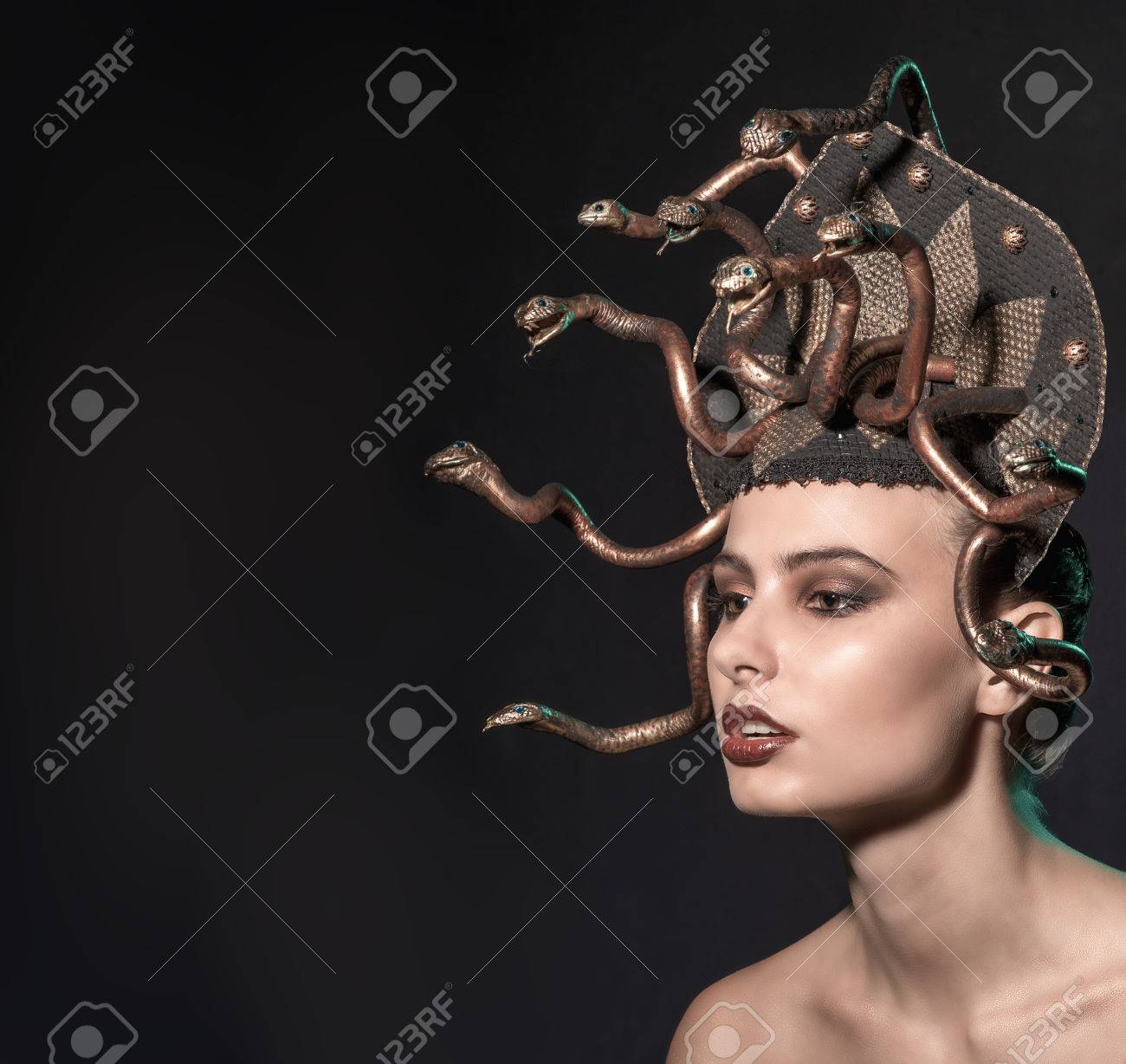 Girl Medusa Headdress Of Gold Color On A Black Background Stock