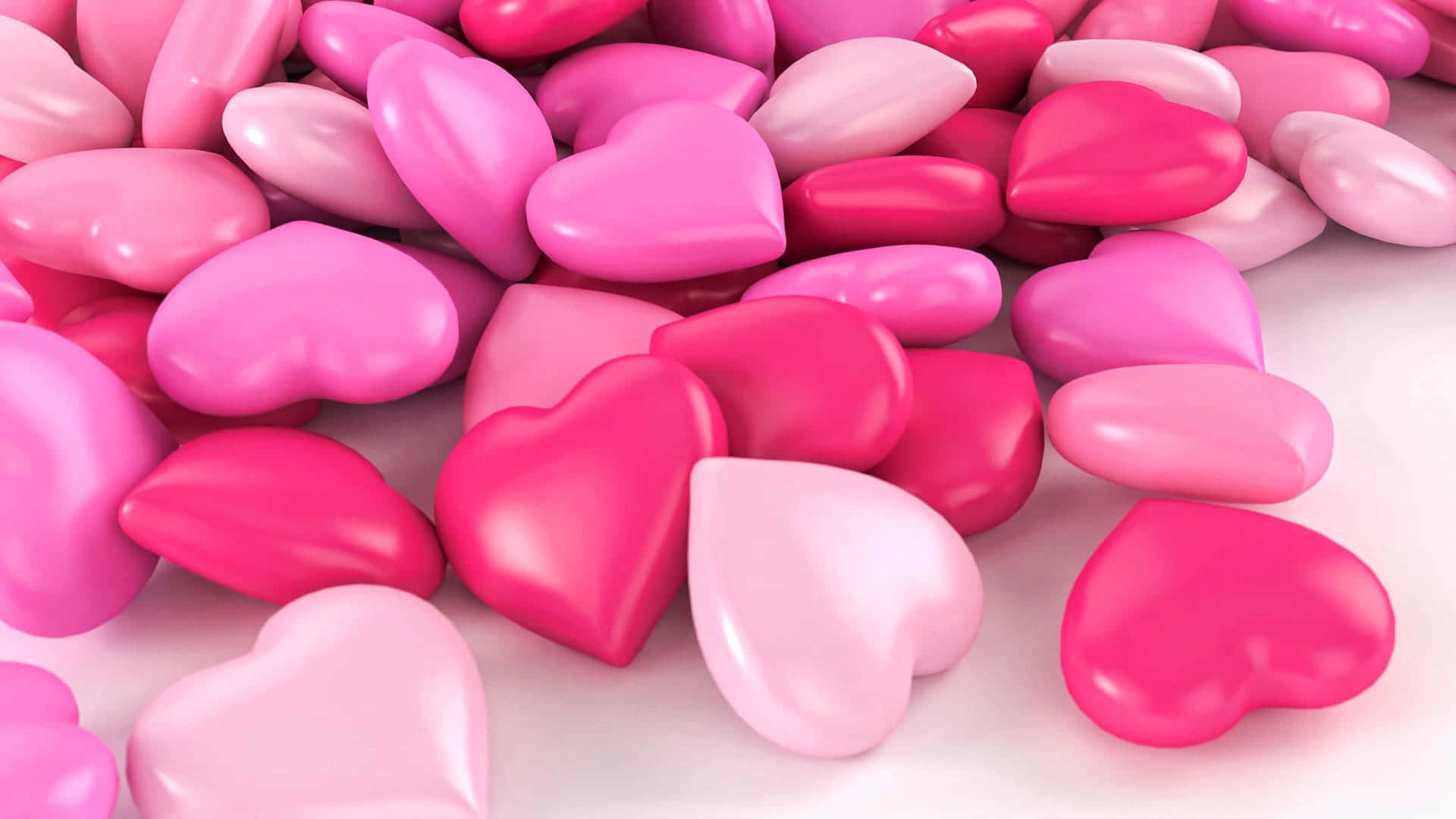 A Pile Of Pink And Hearts On White Surface Wallpaper