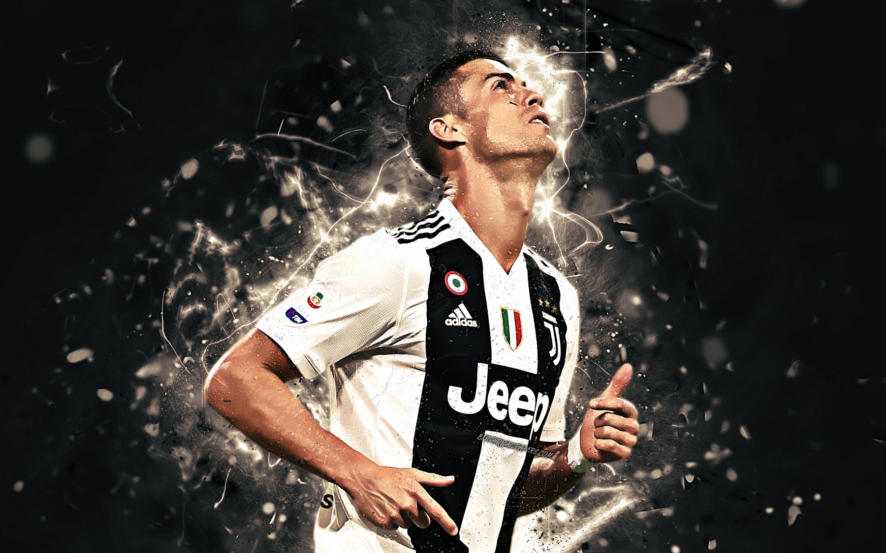 Cristiano Ronaldo in a Juventus jersey, looking up with determination, surrounded by electric effects