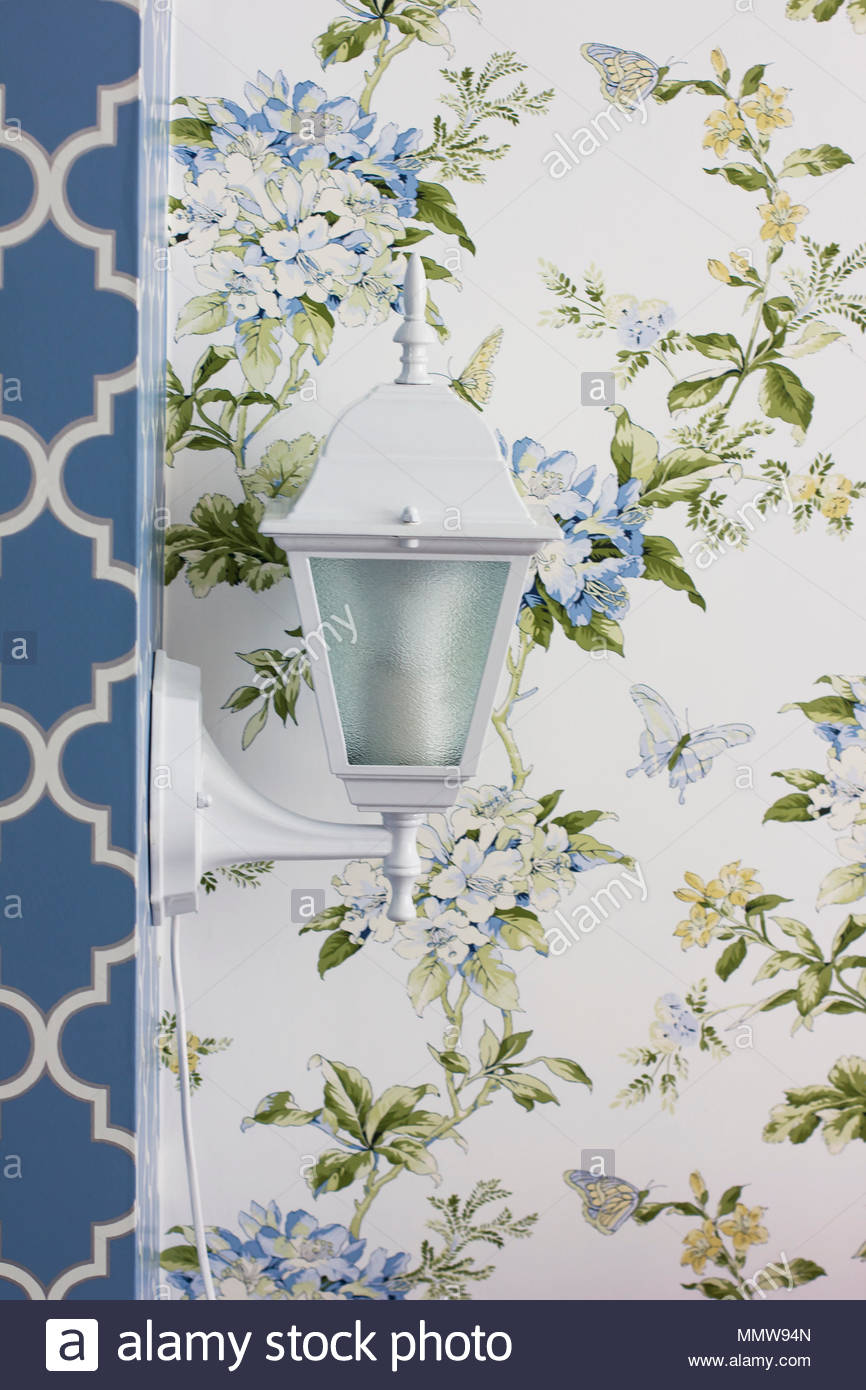 White Sconce Lamp On The Wall With Floral Wallpaper Interior