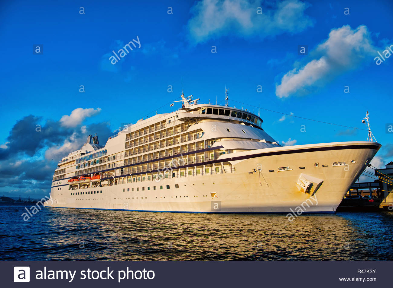 Large Luxury Cruise Ship On Sea And Cloudy Sky At Sunset