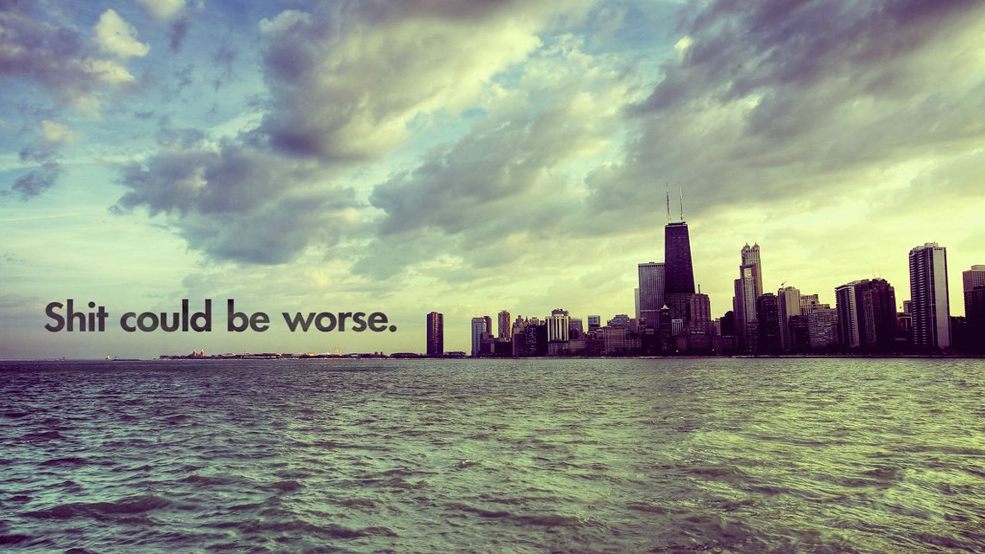 A vintage-style photograph of the Chicago skyline from across Lake Michigan, with the optimistic caption 
