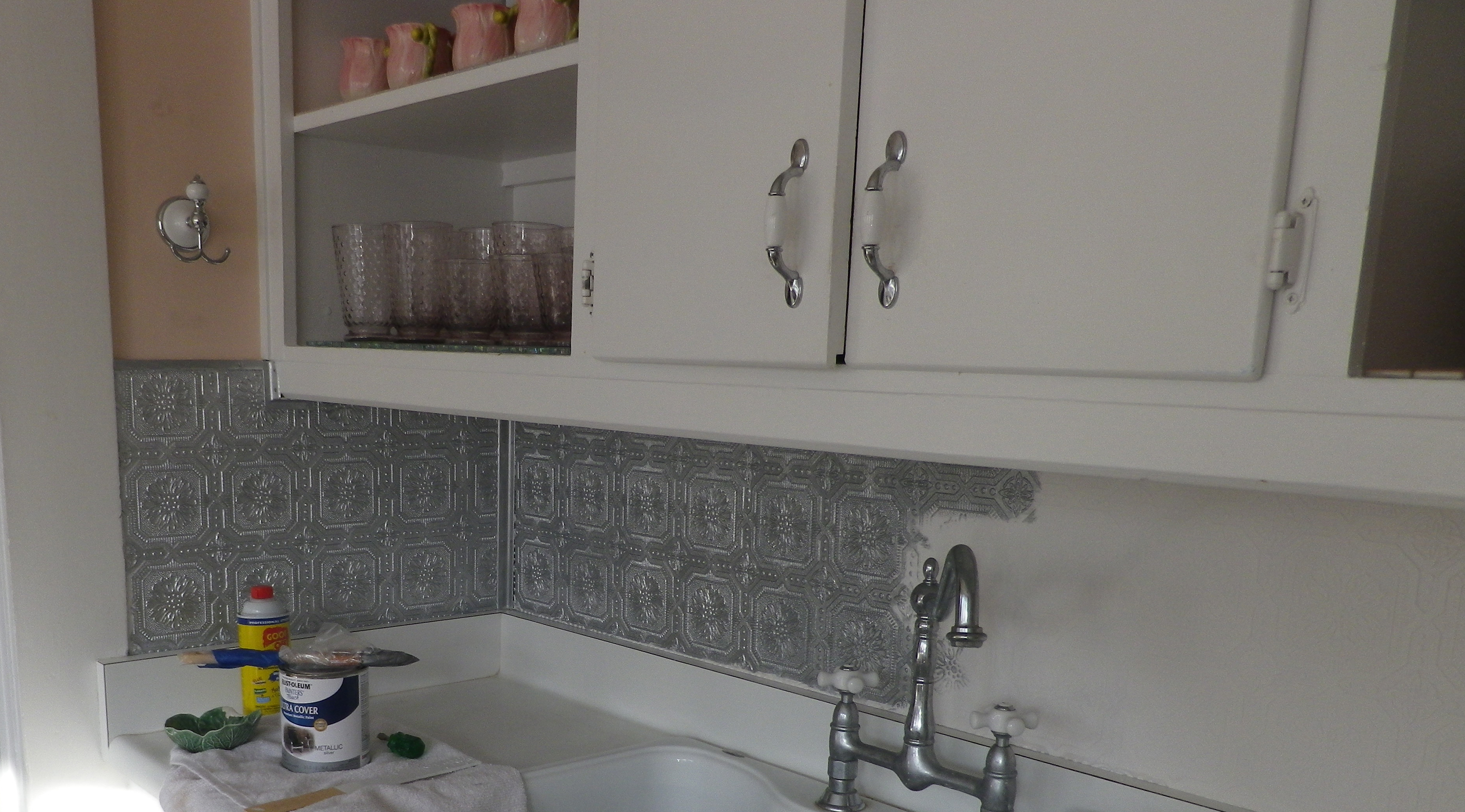 Silver paint on the embossed wallpaper backsplash