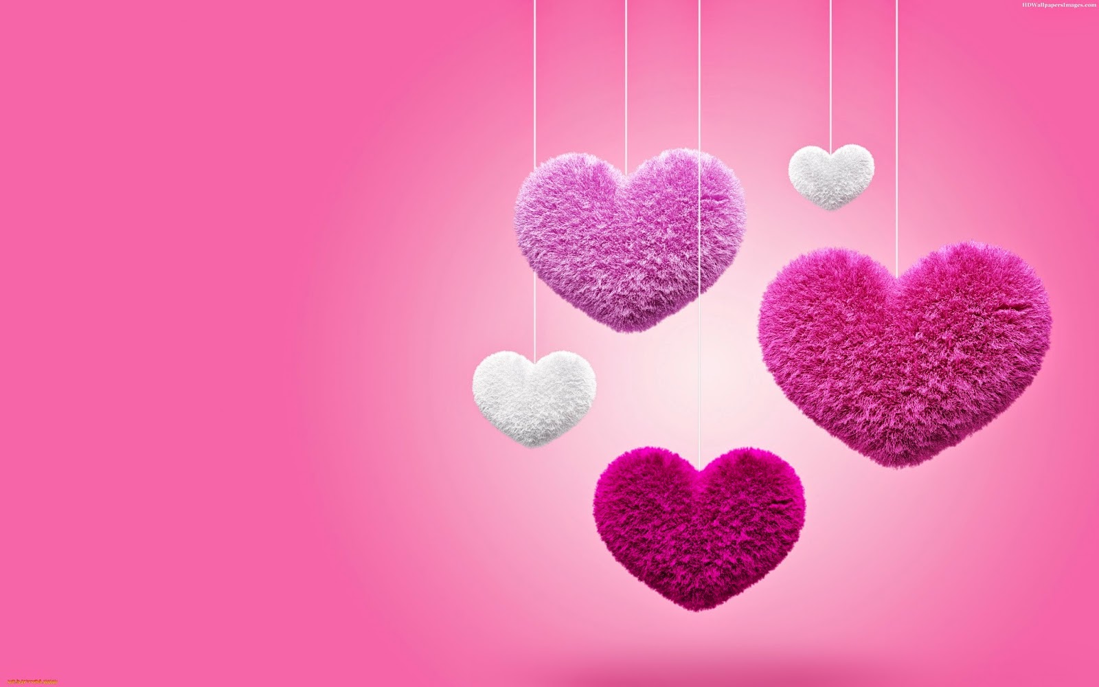 Fluffy pink and white hearts hanging on strings against a pink background