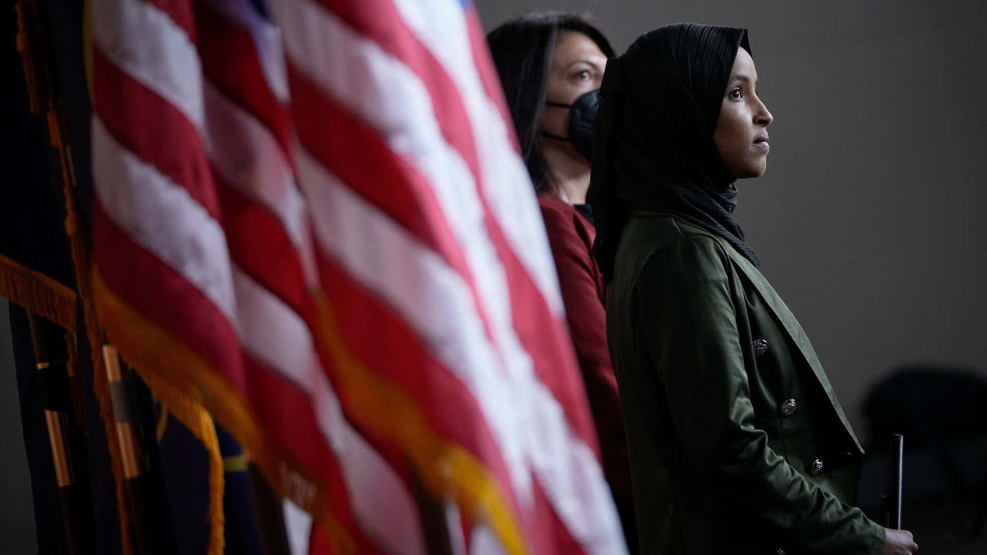 Ilhan Omar Beside The Us Flag Wallpaper