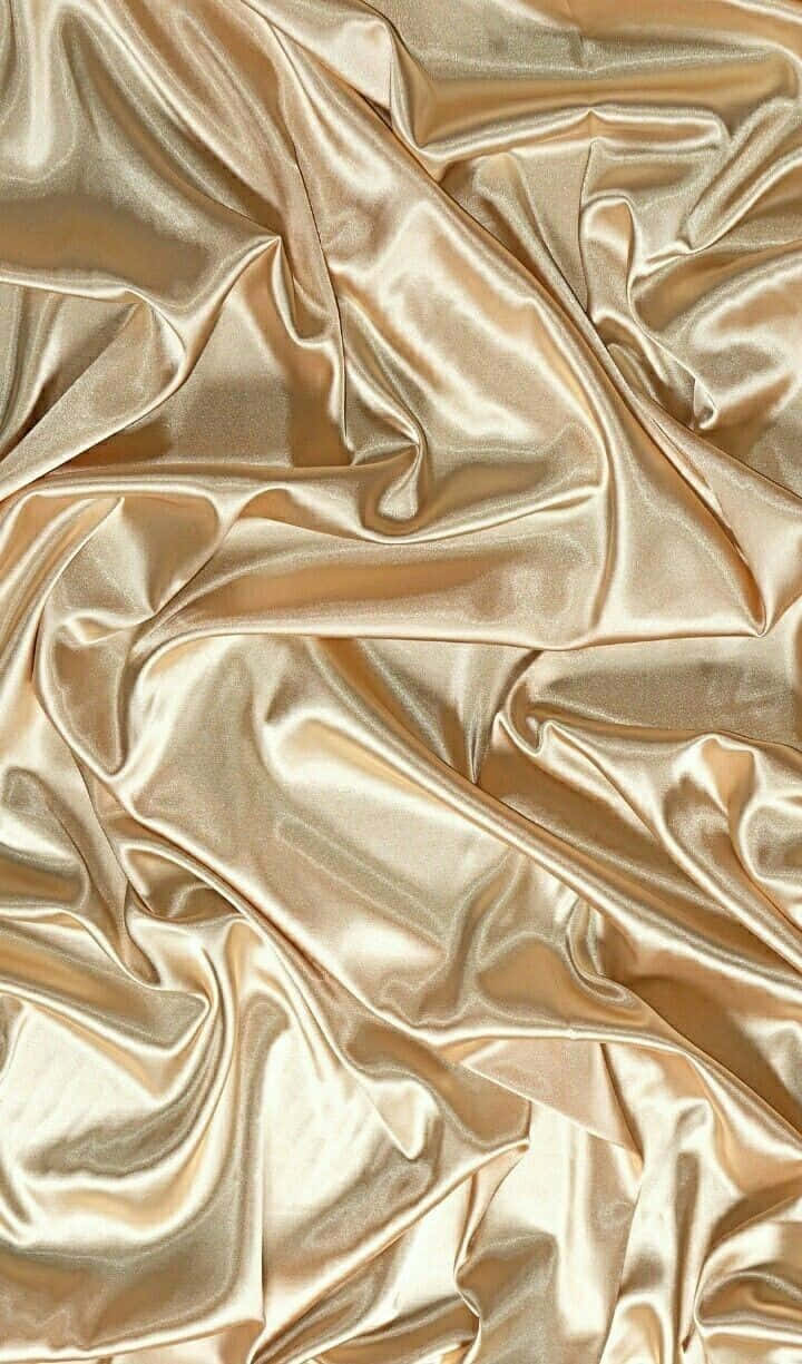 Rich Golden Silk Fabric Shining In The Light Wallpaper