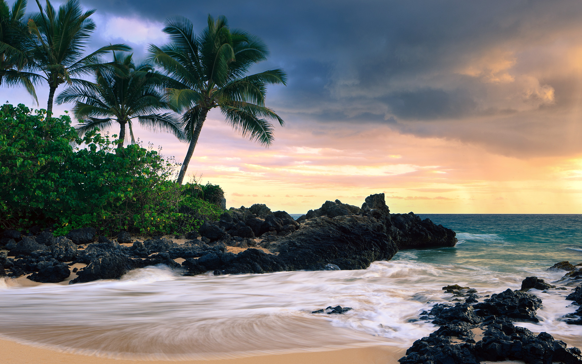 A breathtaking sunset over a secluded Hawaiian beach, with palm trees swaying gently in the breeze. The waves crash against the volcanic rocks, creating a mesmerizing scene