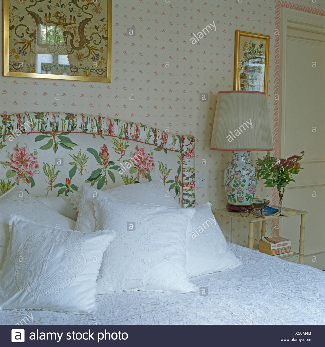 White Lace Edged Cushions On Bed With Upholstered Floral Headboard