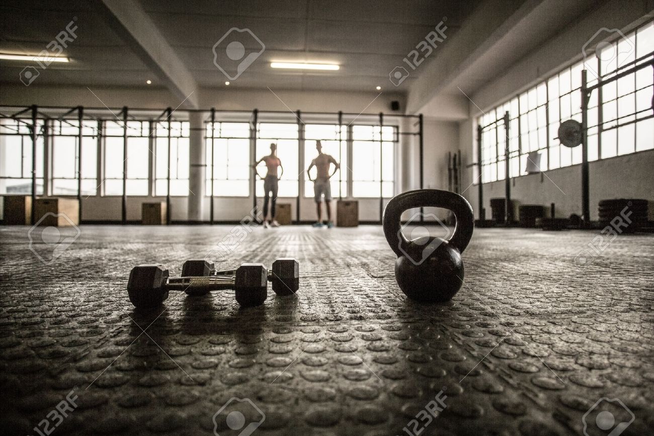 Two Fit People On The Background In Crossfit Gym Stock Photo