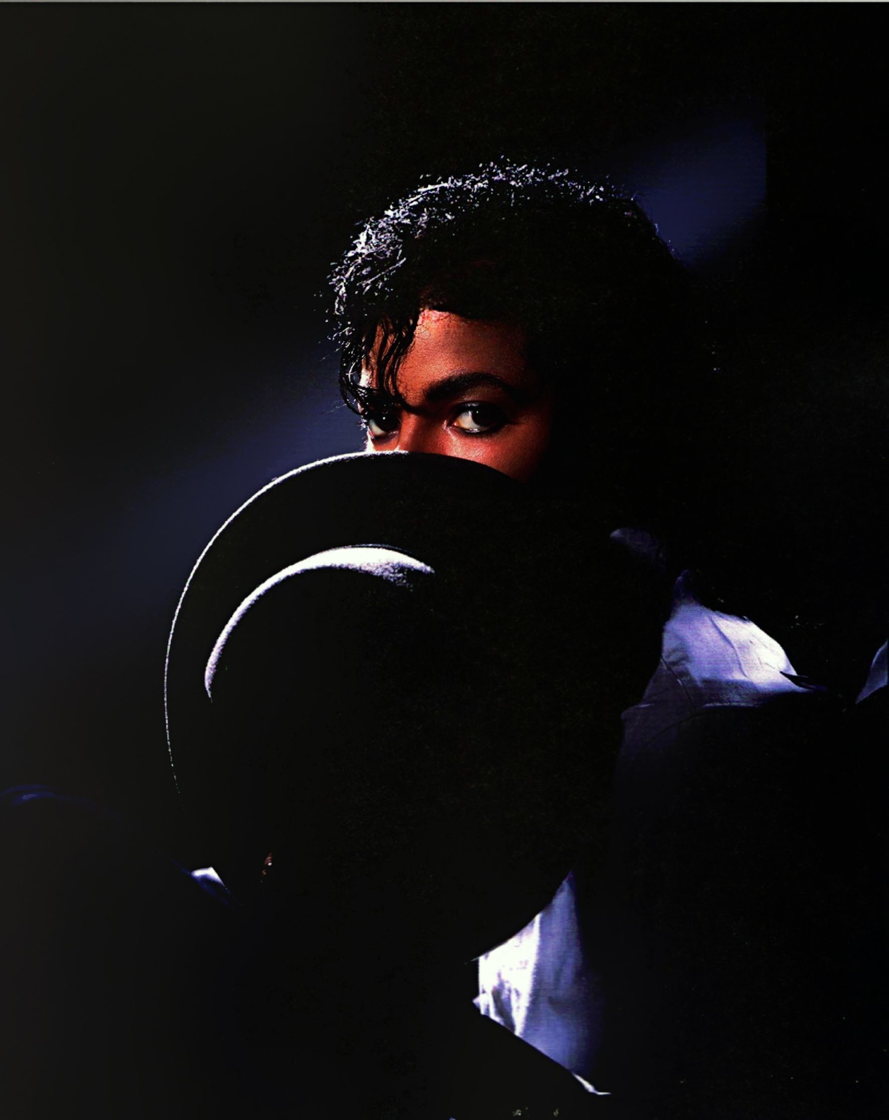 Michael Jackson peering over a fedora