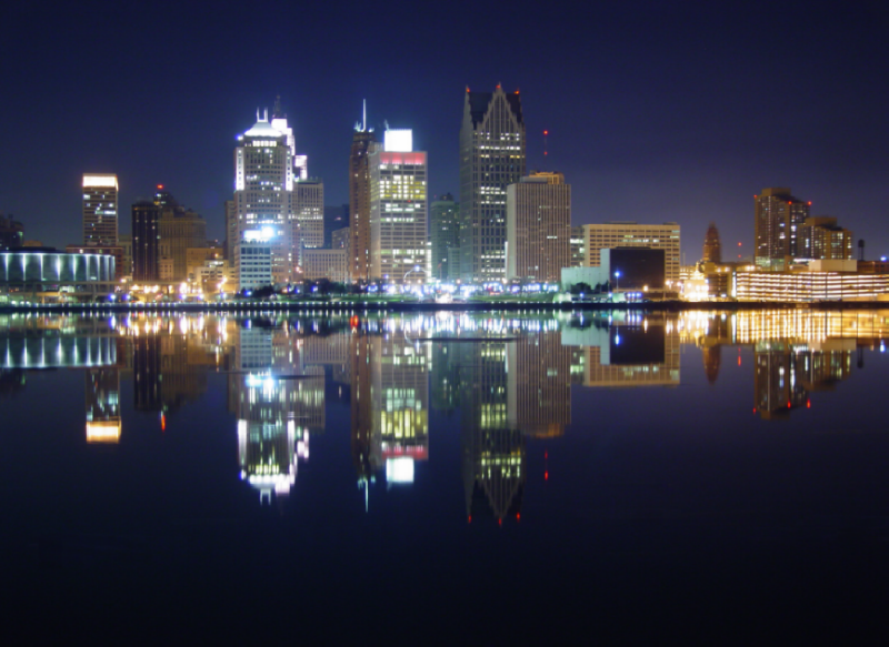 The Motor City At Night Reflecting In Detroit River